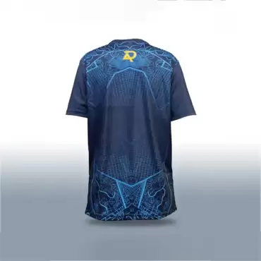 AR 11 Eye Blue Color Cricket Shirt back view featuring a dark navy blue short-sleeve cricket shirt with an intricate bright blue geometric pattern across the upper back and lower section. The upper back displays detailed blue linework, including curved outlines around the shoulders, angular shapes, and a fine grid-like pattern that extends toward the center. A yellow and blue AR-style emblem is positioned at the upper center of the back, just below the neckline. The central back area is predominantly dark navy blue, with subtle blue grid lines forming symmetrical geometric shapes that continue down toward the hem. The lower back features elaborate blue outlined graphics and angular patterns that create a distinctive design along the bottom of the shirt. The sleeves are plain dark navy blue, providing contrast against the patterned back, while the shirt has a rounded neckline, a relaxed athletic fit, and a slightly curved lower hem. It is displayed upright against a plain white and light gray studio background with soft lighting and a subtle shadow underneath, clearly showing the back design, colors, and graphic details. This image shows the back side of the AR 11 Eye Cricket Shirt – Blue Color, available across Pakistan with online delivery from AR Sports.