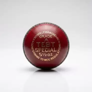AR Sports Red Color Hard Ball shown against a clean white and light gray studio background. The red leather cricket ball is positioned upright in the center, with a raised stitched seam running around its outer edge. Gold lettering on the front reads “ENTIRELY HANDMADE,” “GRADE A,” “TEST SPECIAL,” and “5½ OZ,” with additional text around the design. The ball has a smooth red leather finish with visible stitching and a traditional round hard-ball shape. Soft studio lighting creates a subtle shadow and reflection beneath the ball. The image showcases the AR Sports Red Color Hard Ball, also known as a red leather cricket ball, available for online home delivery across Pakistan.