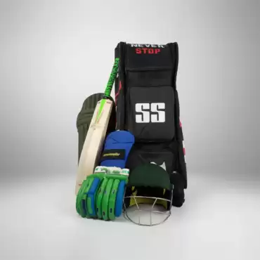 SS Cricket Wicket Keeping Kit – Guardian Edition featuring a black Sareen Sports cricket kit bag with red accents, “NEVER STOP” text in white and red at the top, and a large white SS logo on the front. SS Ton cricket bat with a green and black handle leans against the left side of the bag. In front of the bag are green and blue wicket-keeping gloves, a pair of dark green wicket-keeping leg guards, and a dark green cricket wicket-keeping helmet with a silver metal face grille. The complete kit is arranged together against a clean light gray background, clearly showing the main cricket equipment included in the wicket-keeping set. This image represents a complete SS cricket wicket-keeping kit available for cricket players across Pakistan.