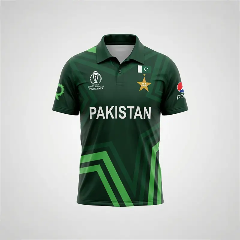 Star Nation Pakistan Cricket Jersey 2023 - Front Side Star Nation Pakistan Cricket Jersey 2023 front view featuring a dark green short-sleeve polo-style cricket shirt with a folded collar, buttoned placket, and geometric green patterning across the fabric. The jersey has large white “PAKISTAN” lettering across the center of the chest, with the Pakistan cricket star emblem and Pakistan flag detail on the upper right chest, and the ICC Cricket World Cup India 2023 tournament logo on the upper left chest. A Pepsi sponsor logo is visible on the right sleeve, while a green sponsor-style emblem appears on the left sleeve. Bright green and darker green angular stripes form a prominent geometric design across the lower front of the jersey, extending diagonally from the sides toward the bottom hem. The jersey is displayed upright against a plain light gray background with even studio lighting, showing the full front design and overall shape of the Star Nation Pakistan Cricket Jersey 2023.